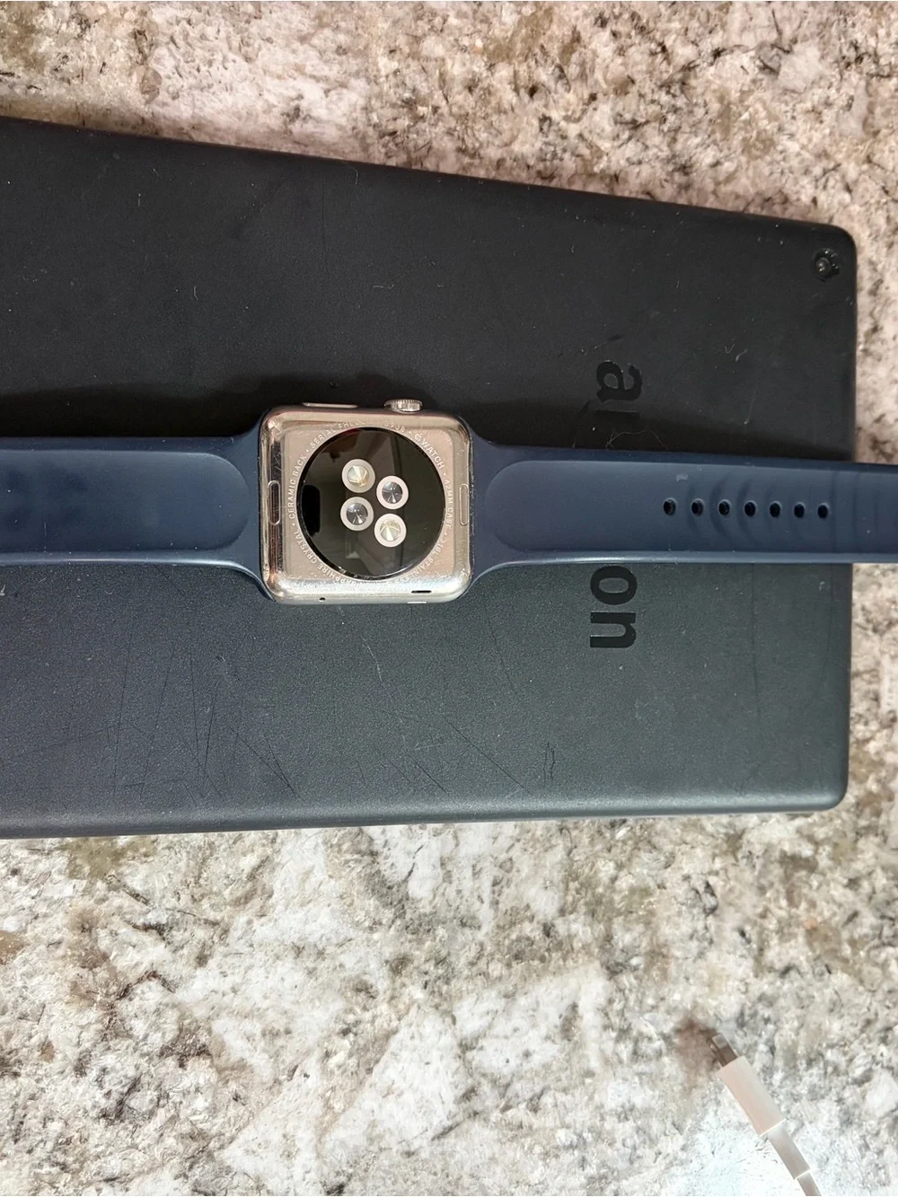 Apple Watch with Navy Blue Sport Band and White Charger